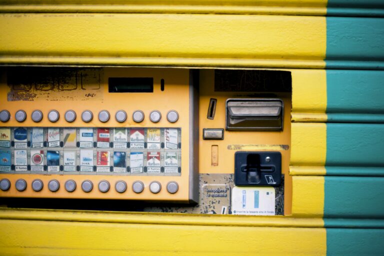 Detailed view of a vibrant yellow and green cigarette vending machine interface.